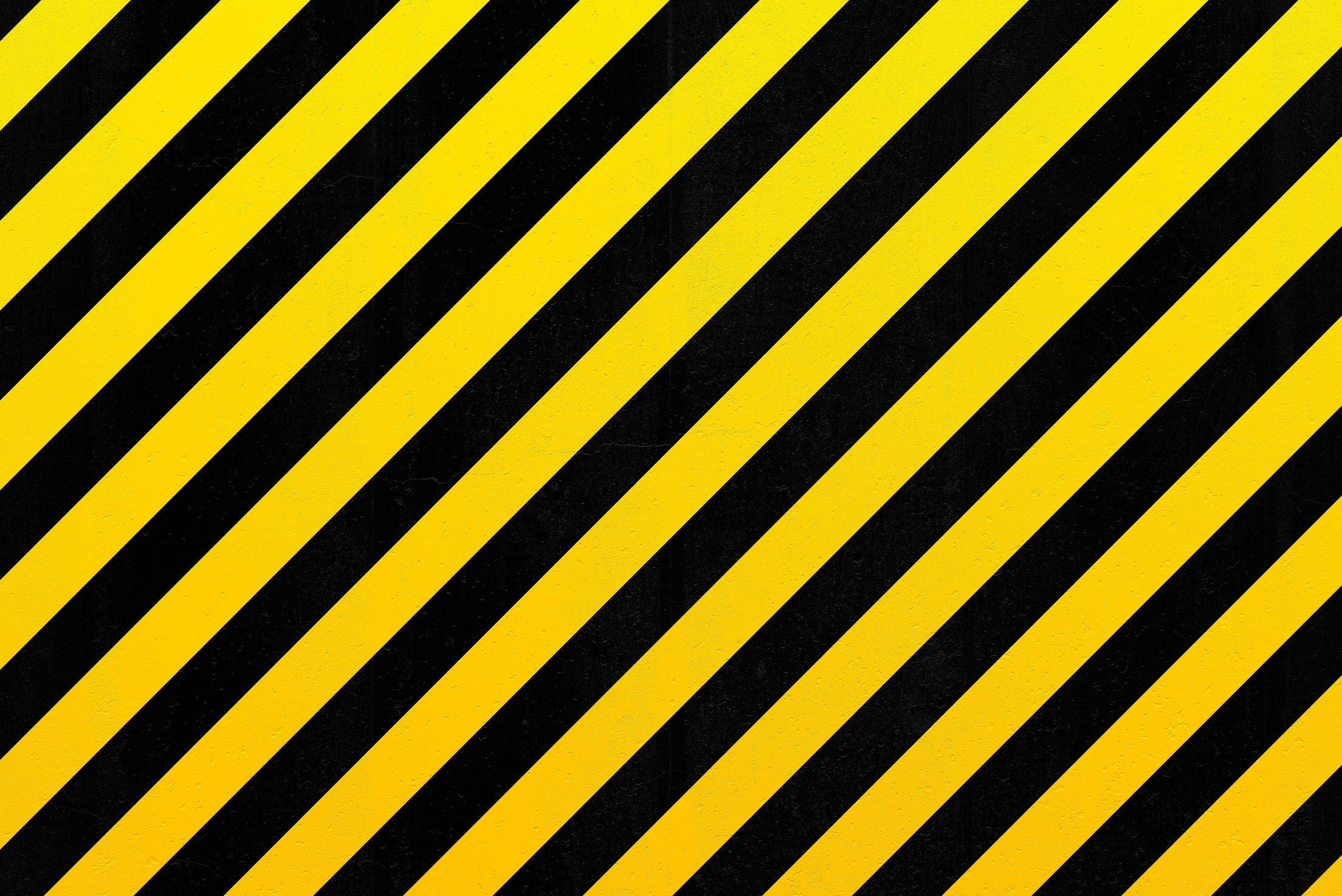 Concrete wall with black and yellow stripes